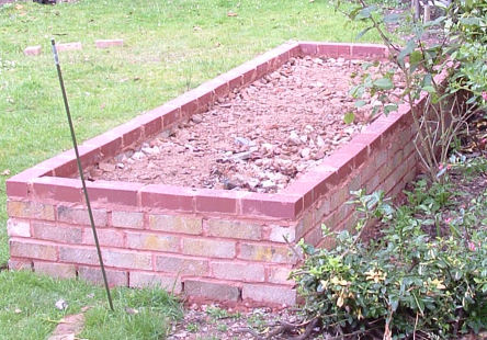 Completed brick walls with rubble in fill